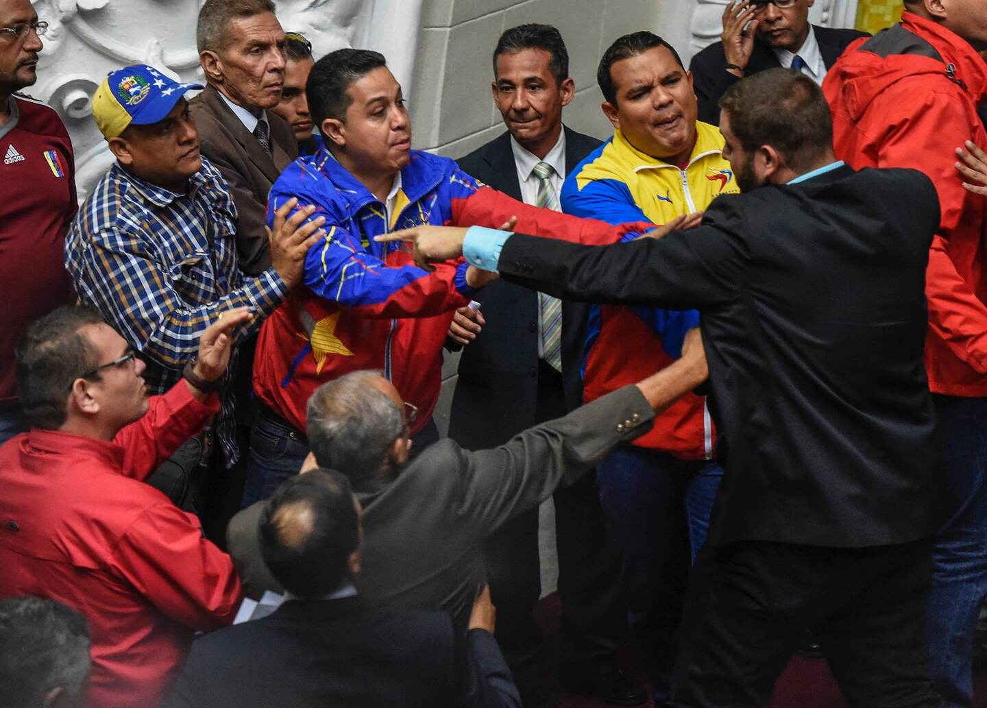 Diputados de la oposición y del chavismo (izquierda) se enfrascaron en discusiones el martes durante un momento de la sesión de la Asamblea Nacional, en Caracas.