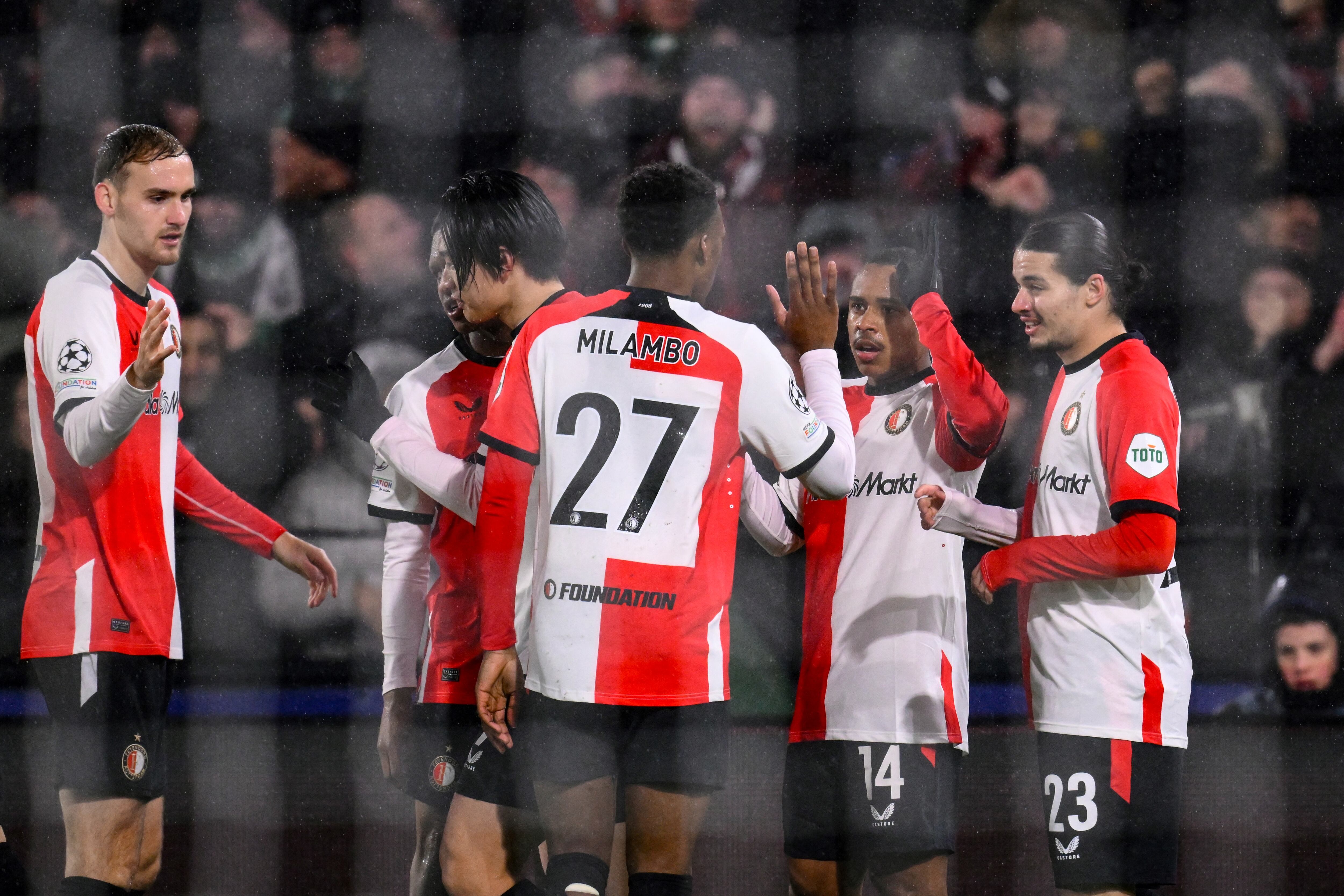 Feyenoord's Brazilian forward #14 Igor Paixao (2nd R) celebrates with teammates after scoring the opening goal during the UEFA Champions League knockout phase play-off 1st leg football match between Feyenoord Rotterdam and AC Milan at the Stadion Feijenoord "De Kuip" in Rotterdam, on February 12, 2025. (Photo by JOHN THYS / AFP)