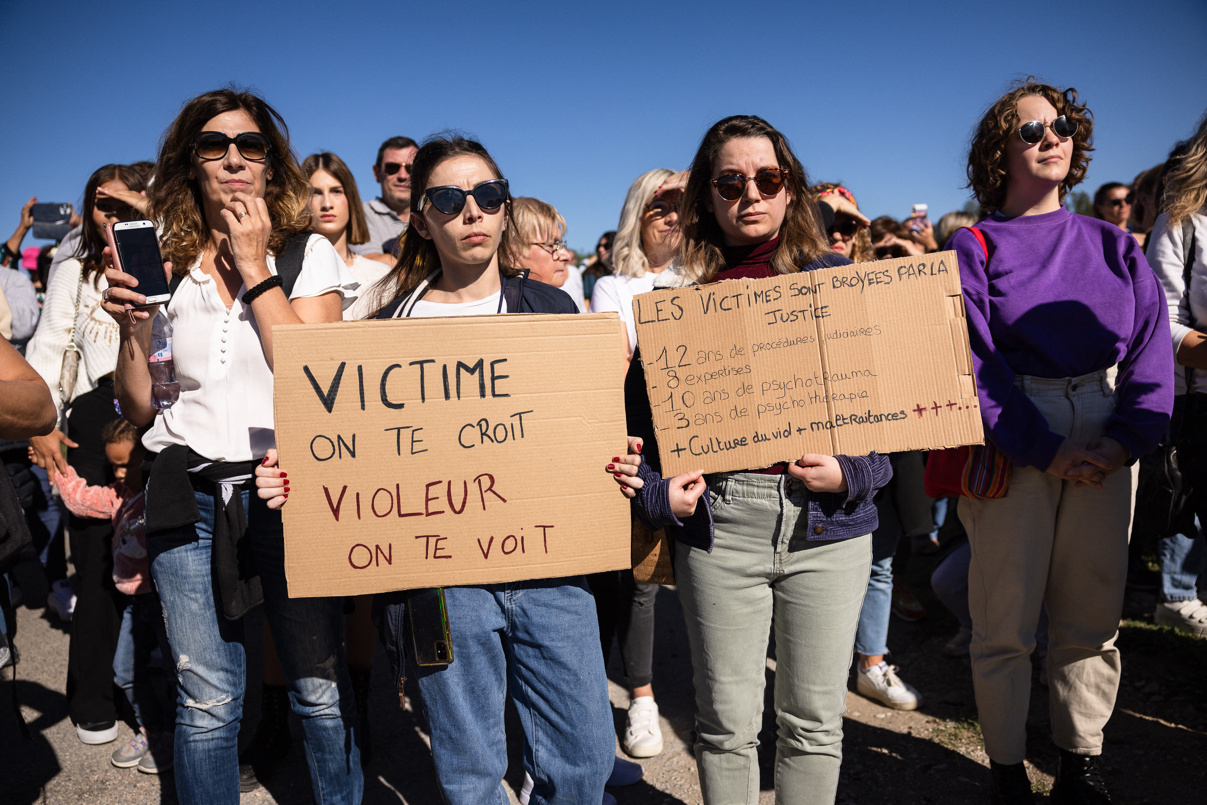 Mujeres sostienen carteles con la leyenda 'Víctimas, les creemos. Violadores, les vemos' y 'Las víctimas son aplastadas' durante una marcha en el pueblo de Mazan y sus alrededores, en el sureste de Francia, para apoyar a Gisele Pelicot y protestar contra la violencia hacia las mujeres.