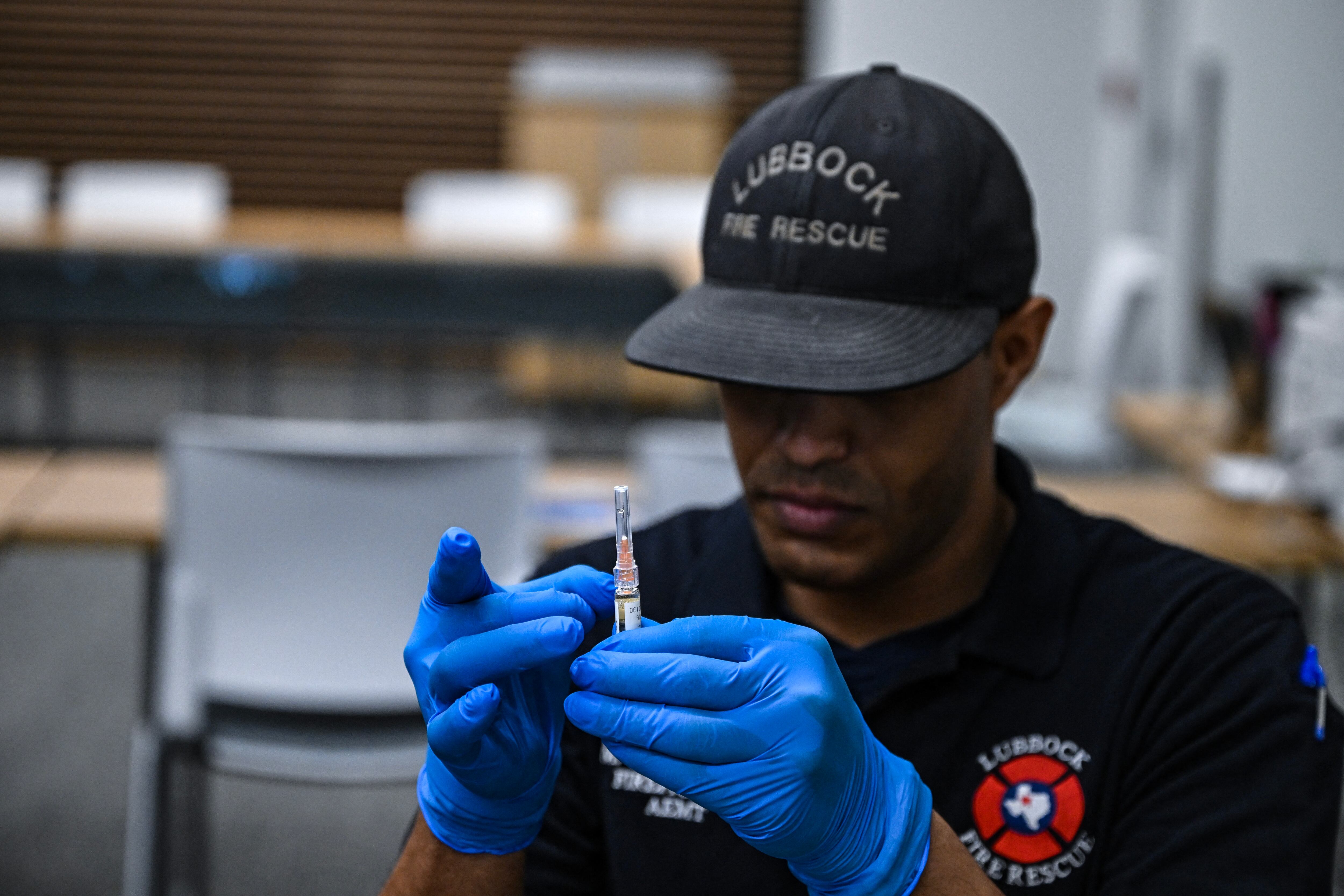 A paramedic administers a dose of the measles vaccine at a health center in Lubbock, Texas, on February 27, 2025. Dozens of children are being rushed to a health center in the US state of Texas to get the measles vaccine, after the recent death in the area of a child who was not immunized against the highly contagio