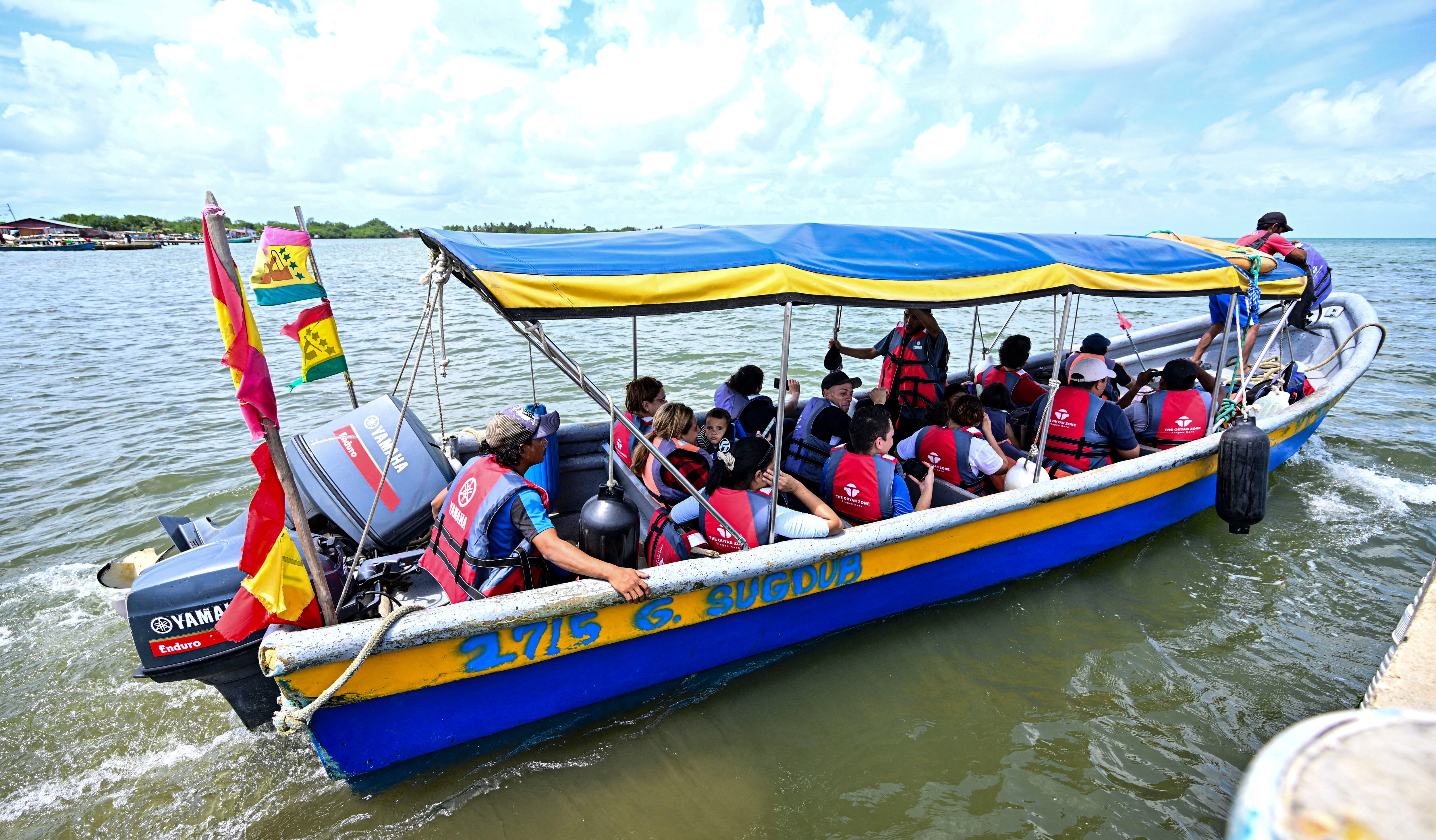 Venezuelan migrants from the US sali in a boat heading to the island of Carti, Guna Yala territory in Panama on February 24, 2025. Hundreds of migrants, many of them children, board boats these days in Cart�, in the indigenous region of Guna Yala, in the Panamanian Caribbean. They are on their way south, a journey of about 12 hours to the port of Necocl�, in Colombia, to then