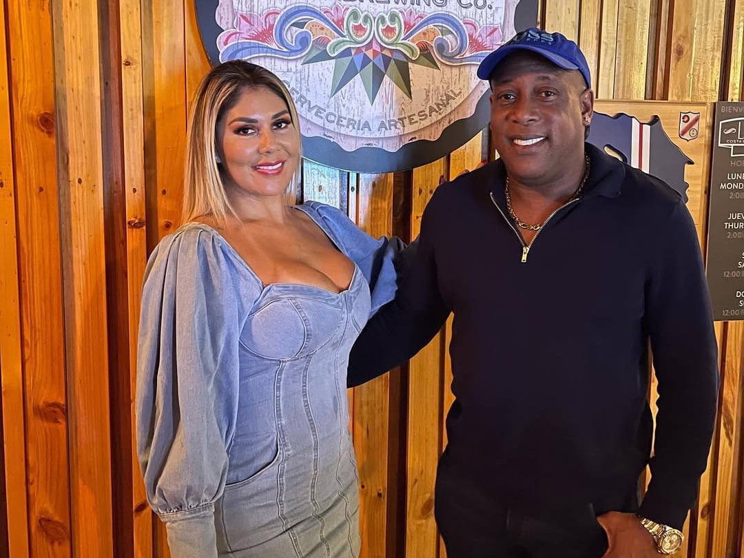 Hernán Medford e Ingrid Solís posando con una pared de madera de fondo.