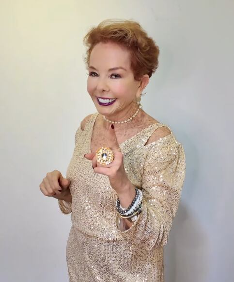 Amanda Moncada, creadora de contenido y experta en moda, vistiendo un elegante vestido dorado y sonriendo hacia la cámara.