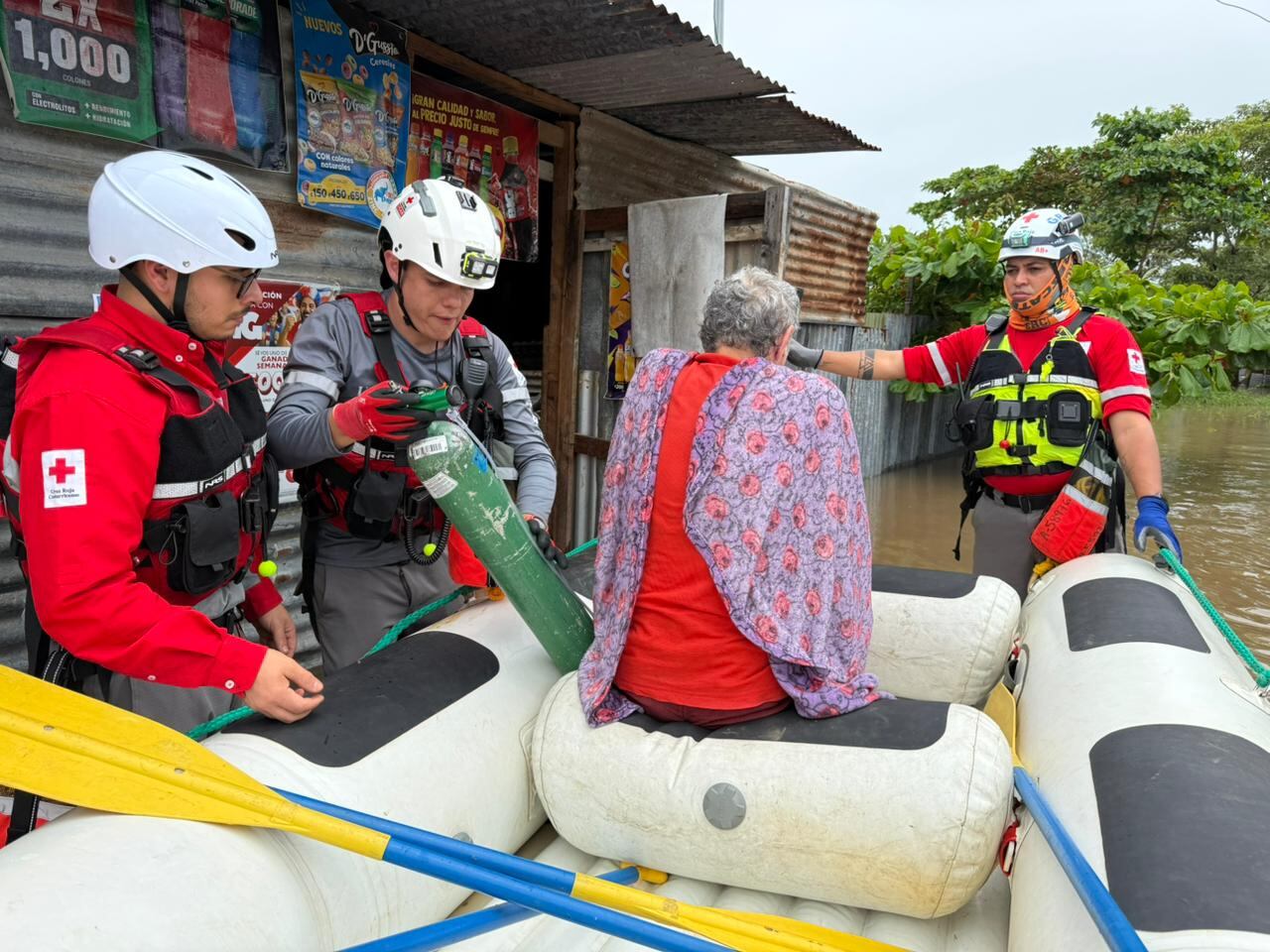 Cruzrojistas rescatan a una persona en un sector inundado en Puntarenas.