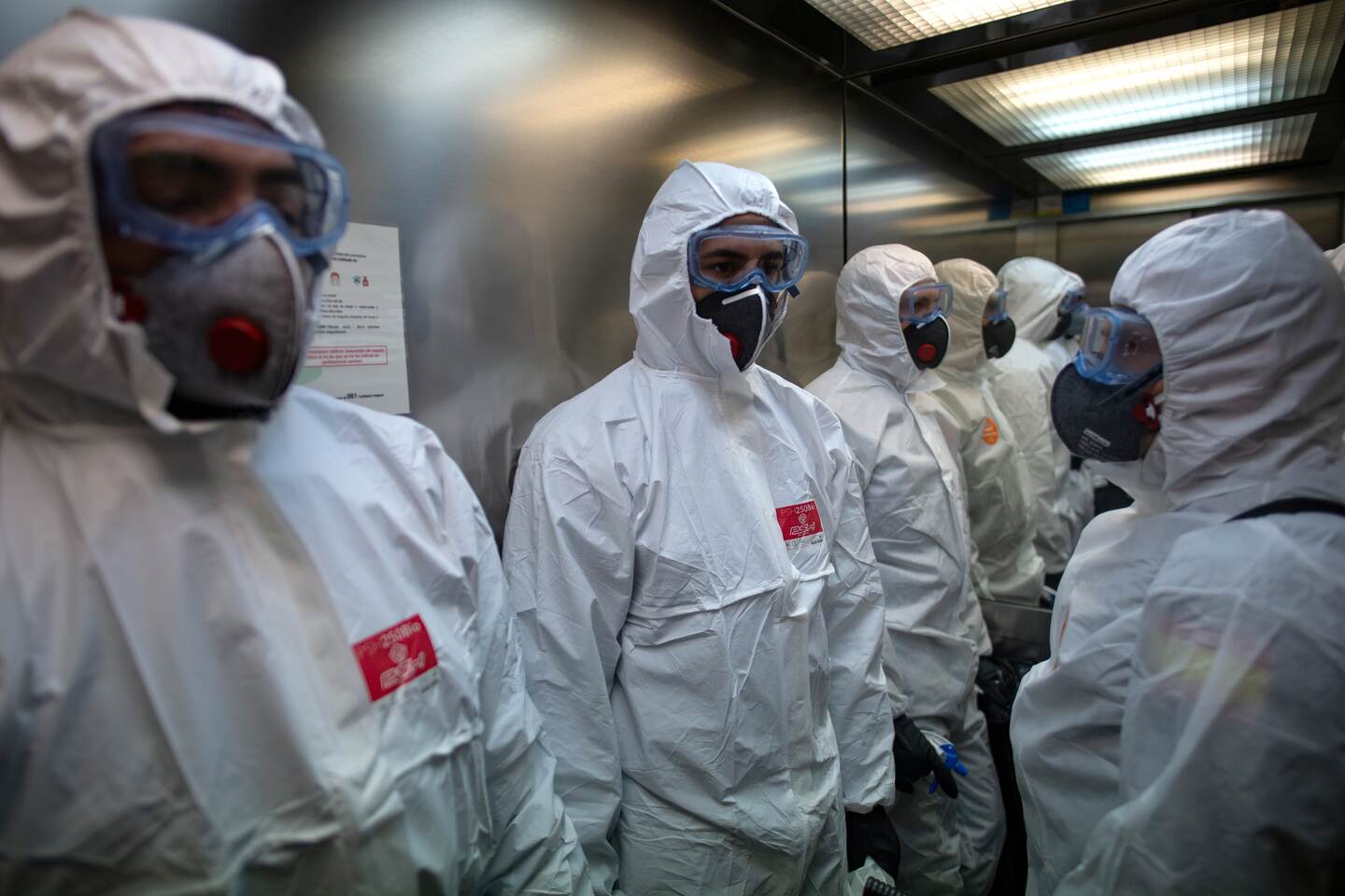 Members of the Military Emergencies Unit (UME) use a lift as they carry out a general disinfection at the Sant Antoni extended care facility in Barcelona on March 27, 2020. - The death toll in Spain soared over 4,800 today after 769 people died in 24 hours, in what was a record one-day figure for fatalities, the government said. Spain has the world's second-highest death toll after Italy, and has so far suffered 4,858 deaths, while the number of cases jumped to 64,059. (Photo by Josep LAGO / AFP)