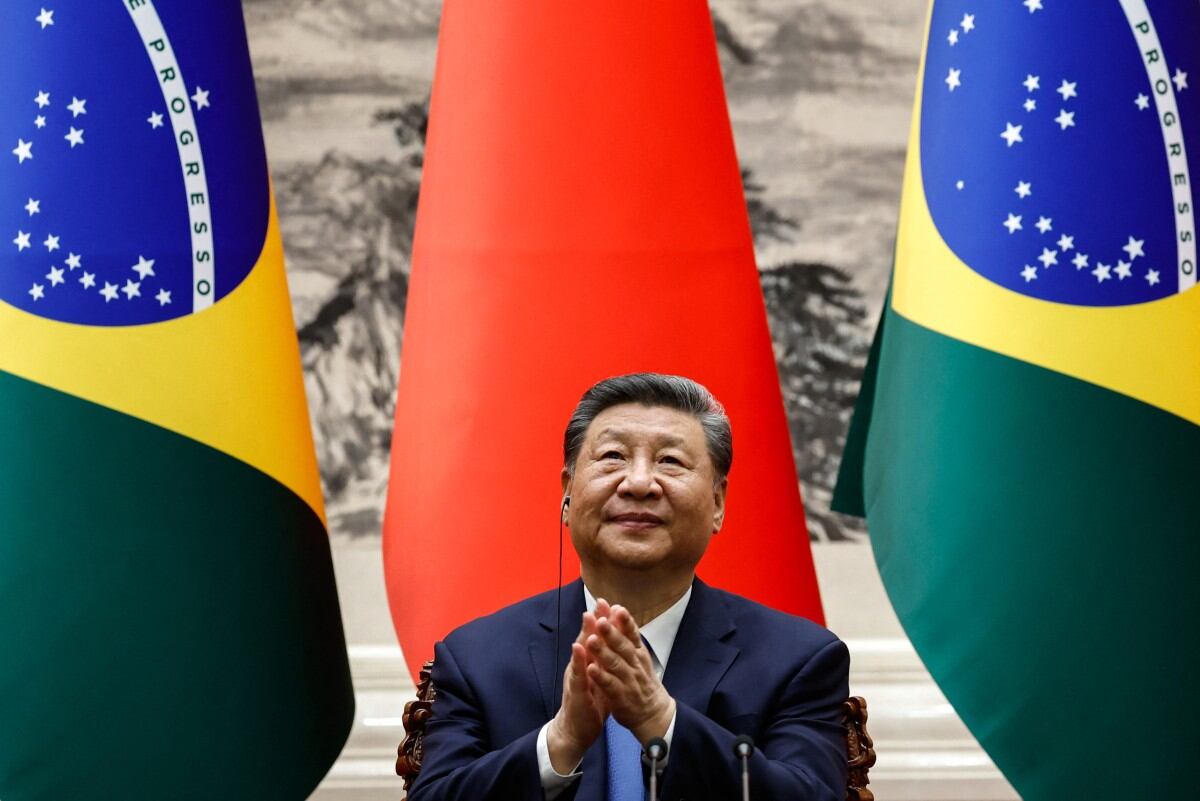 Chinese President Xi Jinping applauds after a joint press conference with Brazil's President Luiz Inacio Lula da Silva (not pictured) at the Great Hall of the People in Beijing on May 13, 2025. (Photo by TINGSHU WANG / POOL / AFP)