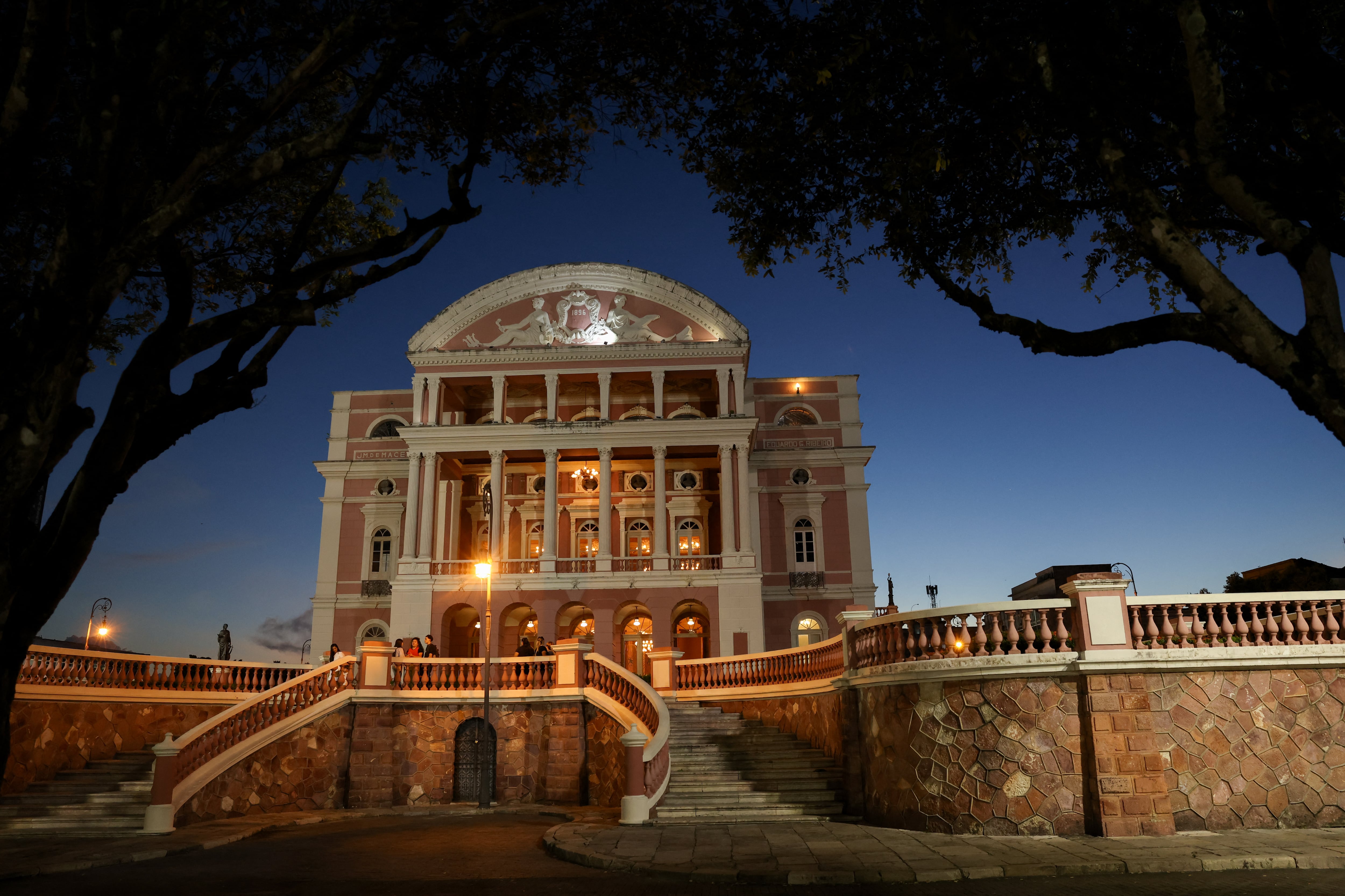 (FILES) The facade of the illuminated Amazonas Theater is seen in Manaus, Amazonas state, northern Brazil, at dusk on July 2, 2026. The Theatre of Peace and the Amazonas Theatre, located in the Brazilian cities of Belem and Manaus respectively, were inscribed on the UNESCO World Heritage List on July 27, 2026. The committee of this UN agency, meeting until on July 29, 2026 in the South Korean city of Busan, highlighted that both theatres represent a legacy of the "golden age" experienced by the Amazon region thanks to the rubber boom between the late 19th and early 20th centuries. (Photo by MICHAEL DANTAS / AFP)
