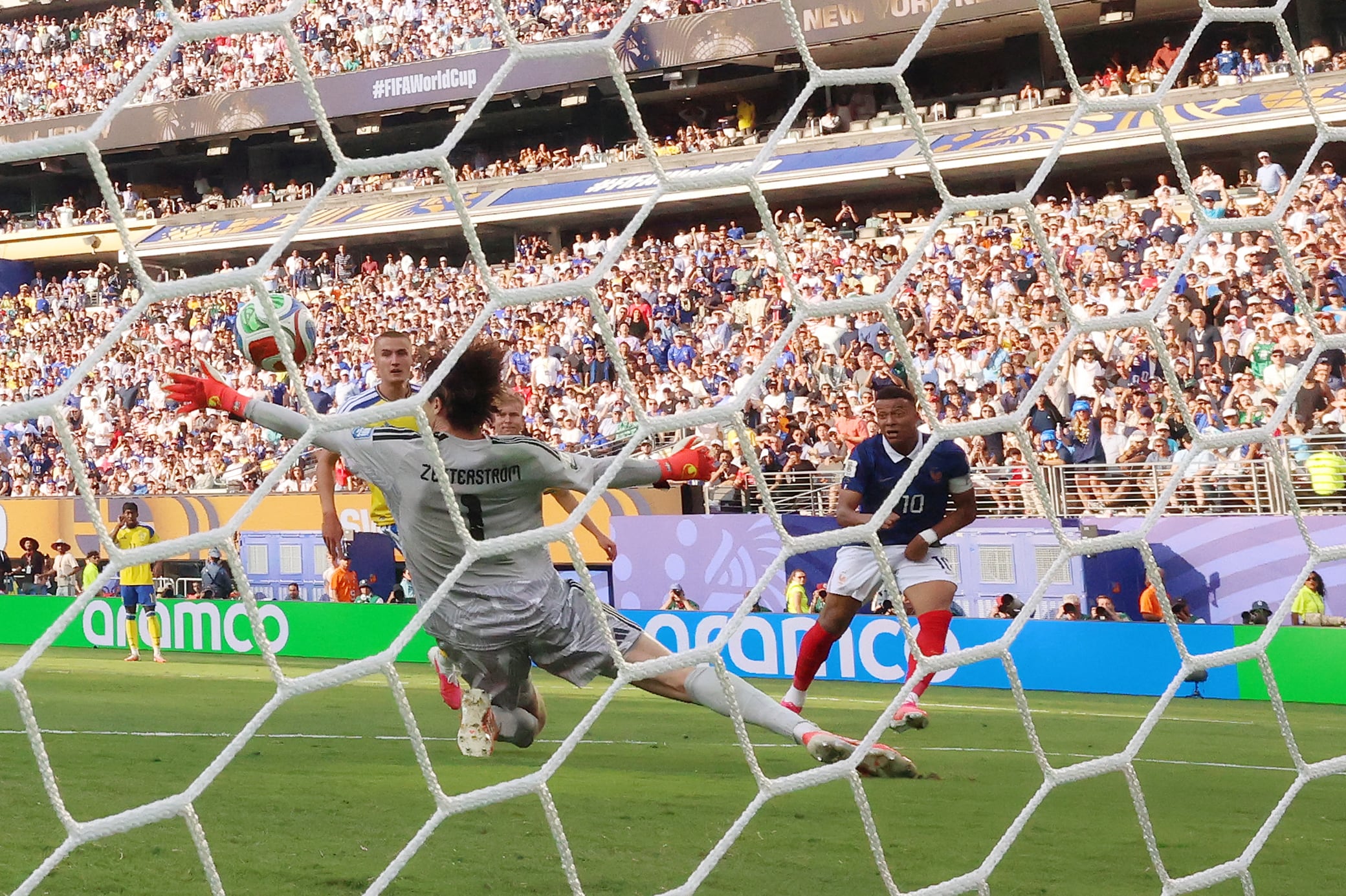 France's forward #10 Kylian Mbappe scores his team's third goal past Sweden's goalkeeper #01 Jacob Widell Zetterstrom during the 2026 World Cup round of 32 football match between France and Sweden at the New York/New Jersey Stadium in East Rutherford on June 30, 2026. (Photo by CHARLY TRIBALLEAU / AFP)