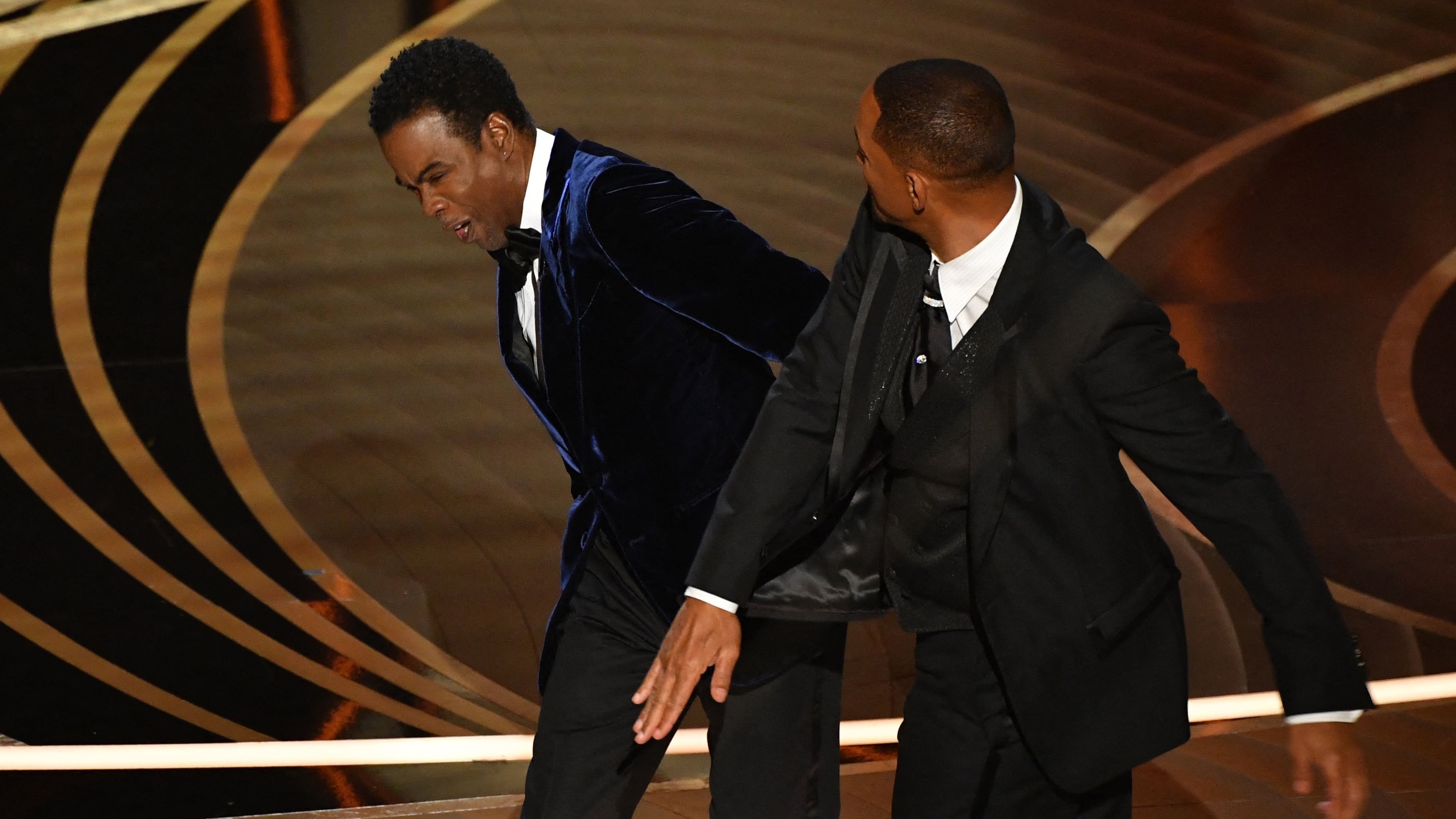 US actor Will Smith (R) slaps US actor Chris Rock onstage during the 94th Oscars at the Dolby Theatre in Hollywood, California on March 27, 2022. (Photo by Robyn Beck / AFP)