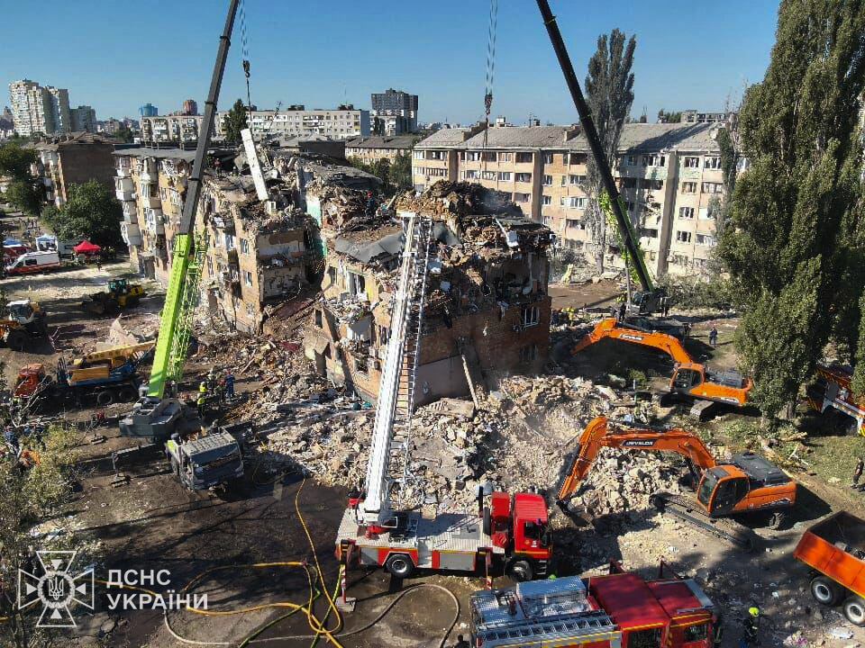 This handout photograph taken and released by the State Emergency Service of Ukraine on August 28, 2025, shows rescuers conducting a search and rescue operation in and around a residential building heavily damaged during a large-scale Russian drone and missile attack on Kyiv, amid the Russian invasion of Ukraine. Russian missiles and drones ripped through apartment blocks in the Ukrainian capital Kyiv early August 28, 2025, killing at least 14 people, including three children, in an attack that President Volodymyr Zelensky said showed Moscow's rejection of peace negotiations. (Photo by Handout / State Emergency Service of Ukraine / AFP) / RESTRICTED TO EDITORIAL USE - MANDATORY CREDIT "AFP PHOTO / STATE EMERGENCY SERVICE OF UKRAINE" - NO MARKETING NO ADVERTISING CAMPAIGNS - DISTRIBUTED AS A SERVICE TO CLIENTS