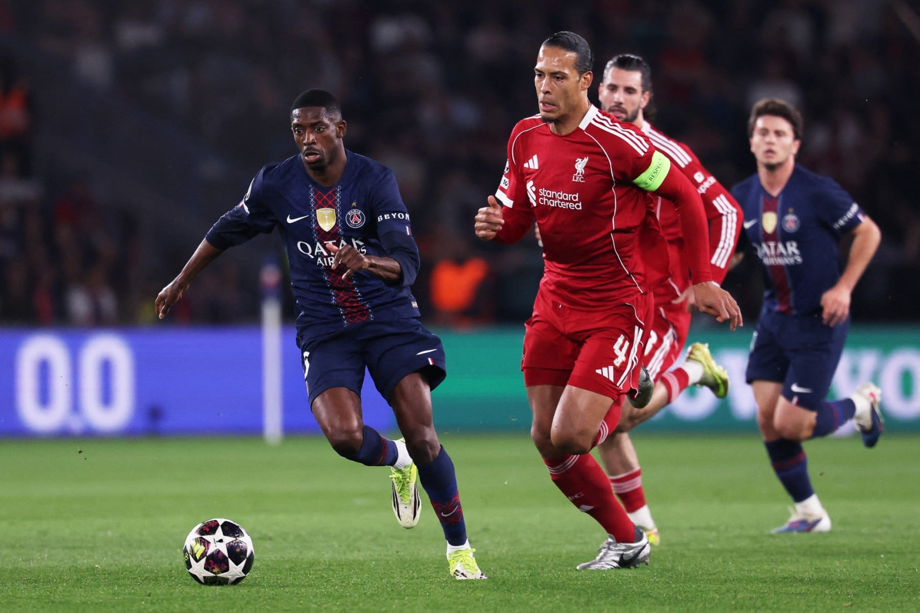 Paris Saint-Germain's French forward #10 Ousmane Dembele (L) fights for the ball with Liverpool's Dutch defender #04 Virgil van Dijk (R) during the UEFA Champions League quarter-final first leg football match between Paris Saint-Germain (PSG) and Liverpool FC at the Parc des Princes stadium in Paris on April 8, 2026. (Photo by FRANCK FIFE / AFP)