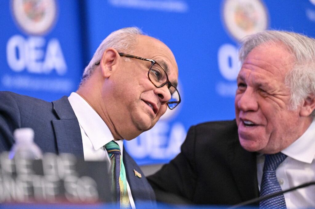 (L-R) OAS Secretary General-elect Albert Ramdin speaks with outgoing OAS Secretary General Luis Almagro during an Organization of American States (OAS) special General Assembly to elect new Secretary General, at OAS headquarters in Washington, DC, on March 10, 2025. Ramdin, the new Secretary General, will serve from 2025 to 2030. (Photo by ROBERTO SCHMIDT / AFP)