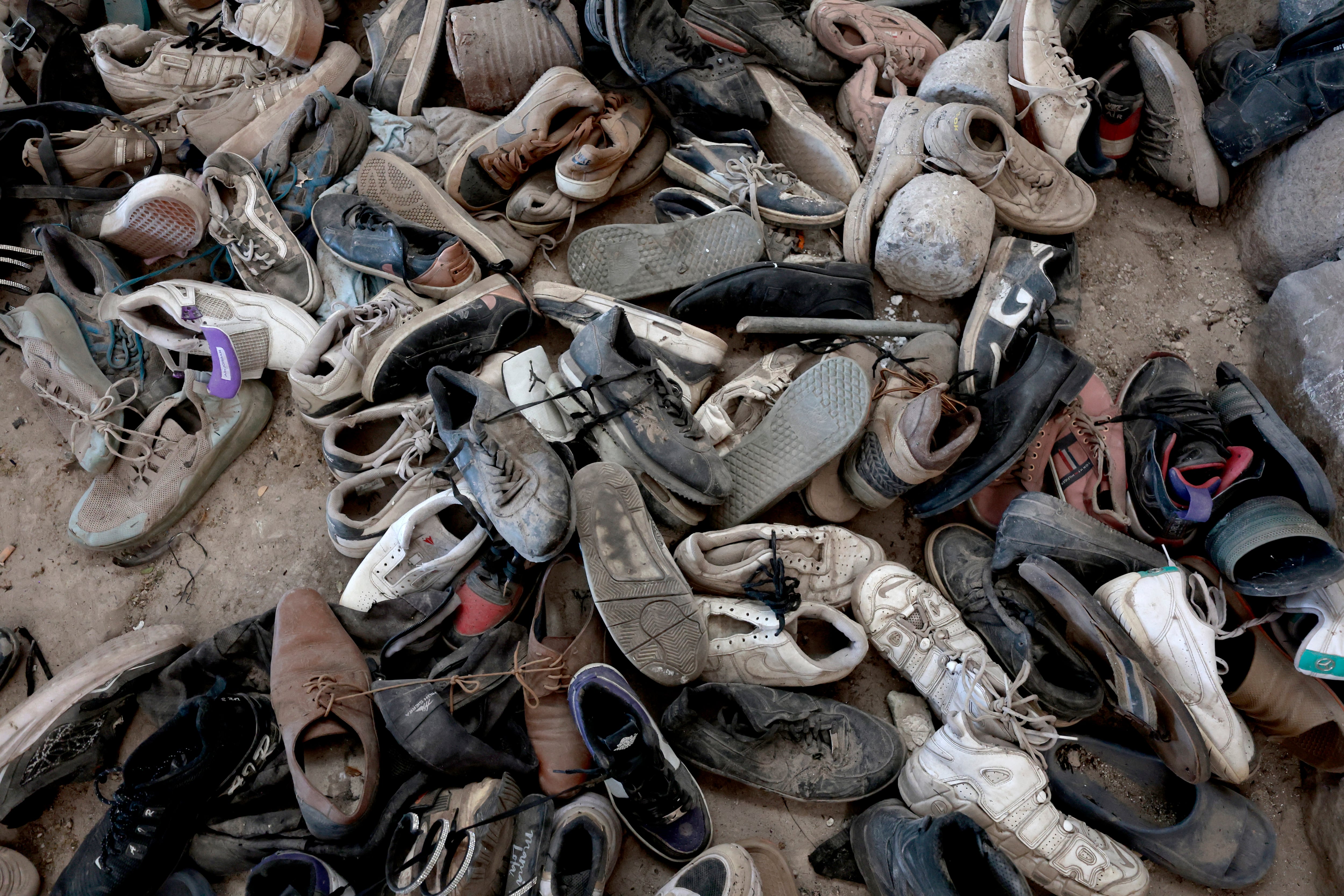 Shoes piled up are seen at the Izaguirre Ranch in the community of La Estanzuela, where the collective 'Guerreros Buscadores' located three human crematoriums while searching for their relatives in Teuchitlan, Jalisco state, Mexico on March 5, 2025. Mexico's