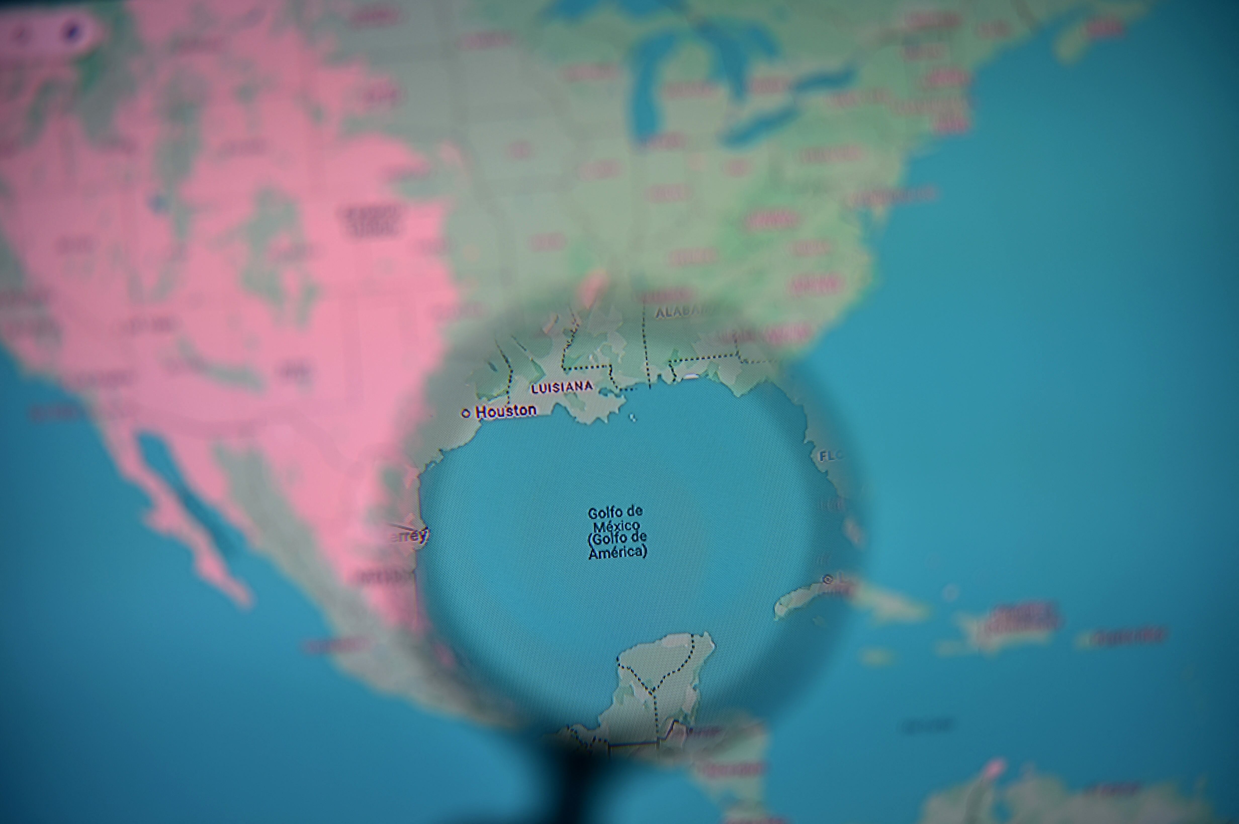The Gulf of Mexico branded as Gulf of America is pictured through a magnifying glass on the Google Maps app on a computer in Bogota on February 11, 2025. Google on February 10, 2025 changed the name of the Gulf of Mexico to "Gulf of Amer