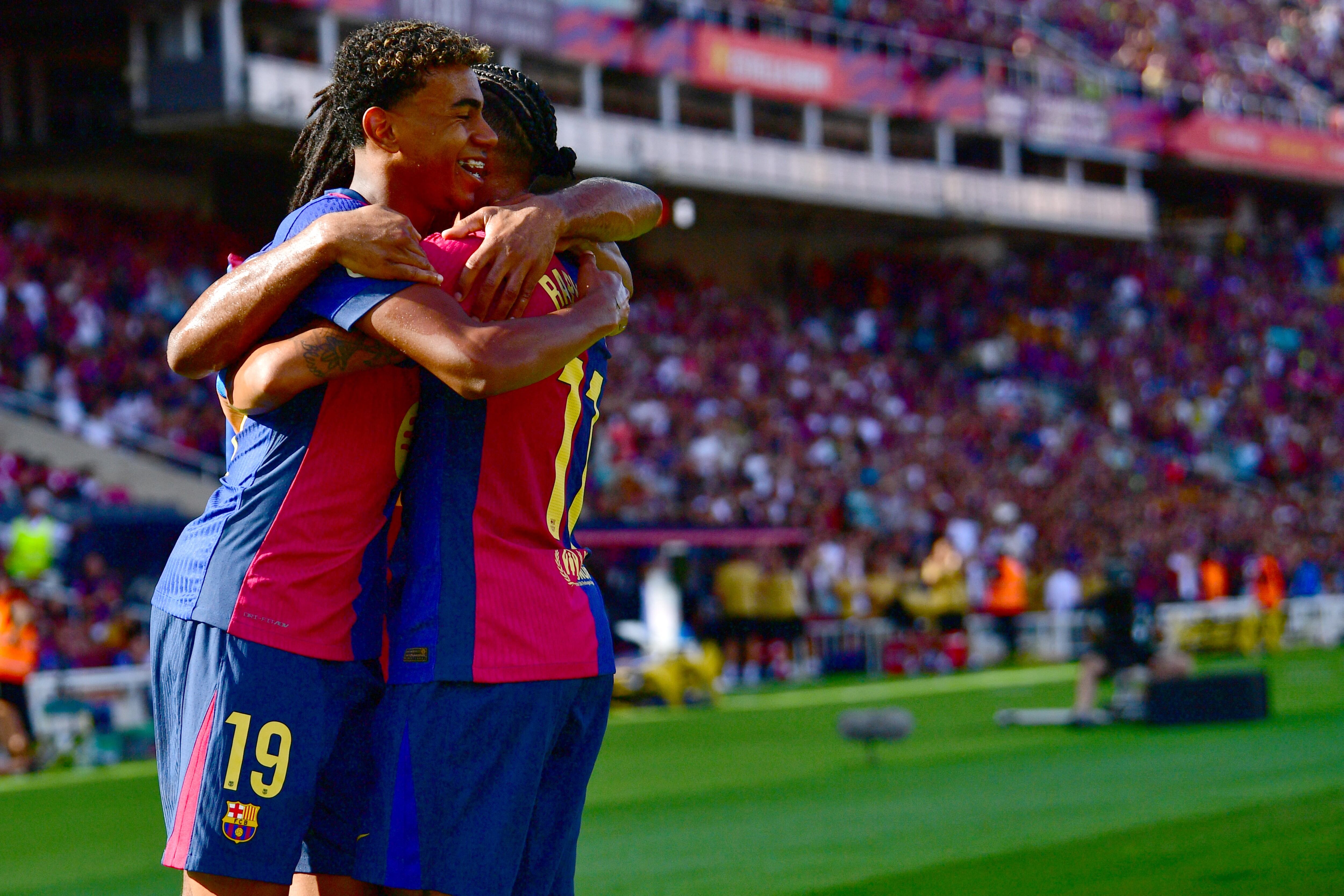 Barcelona's Brazilian forward #11 Raphinha celebrates scoring his team's first goal with Barcelona's Spanish forward #19 Lamine Yamal during the Spanish league football match between FC Barcelona and Real Valladolid FC at the Estadi Olimpic Lluis Companys in Barcelona on August 31, 2024. (Photo by MANU QUINTERO / AFP)
