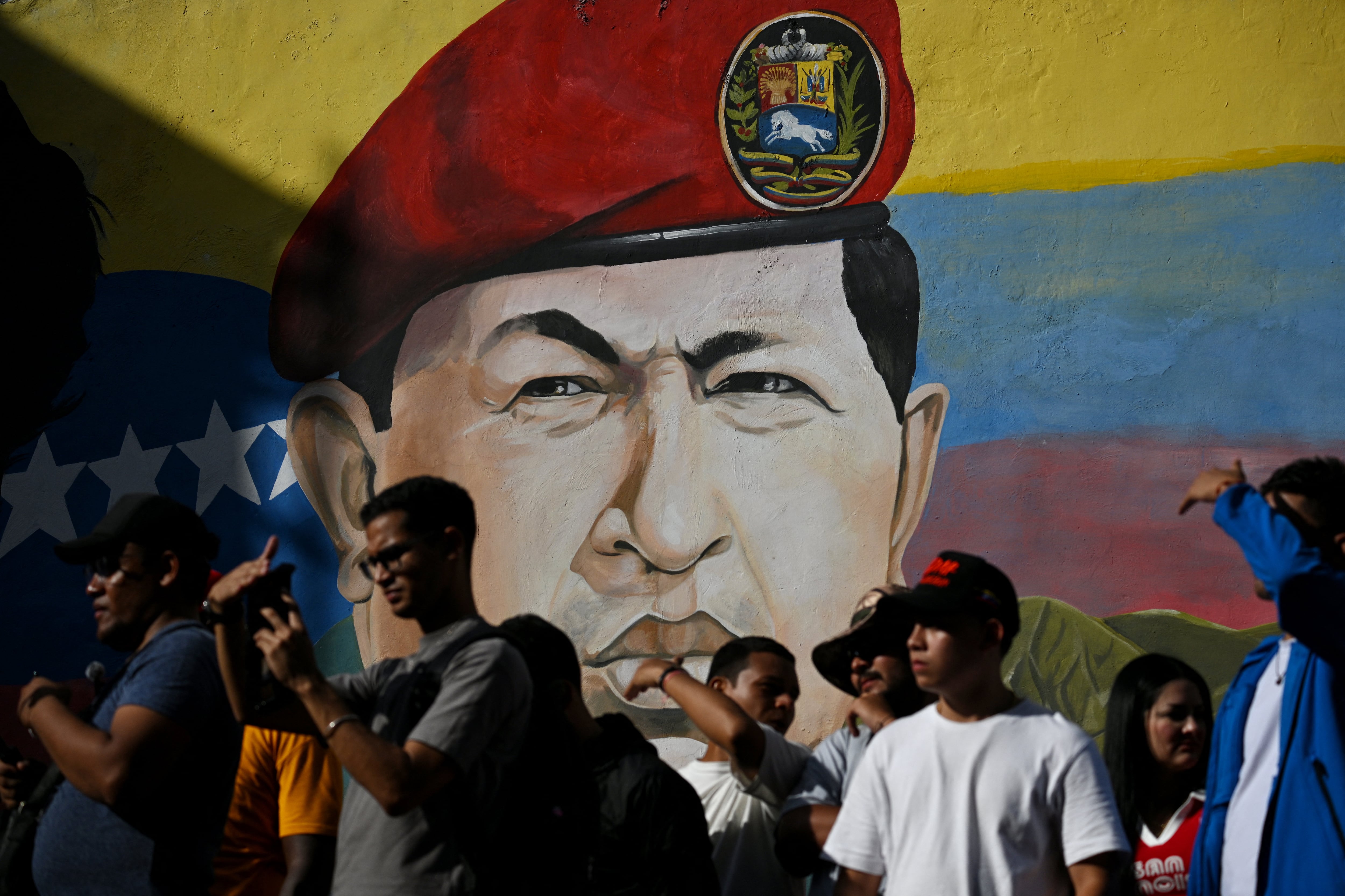 Un mural que representa al ex presidente venezolano Hugo Chávez se observa durante una marcha de simpatizantes del gobierno en el Día Internacional de la Juventud, en Caracas, el 12 de febrero de 2026.