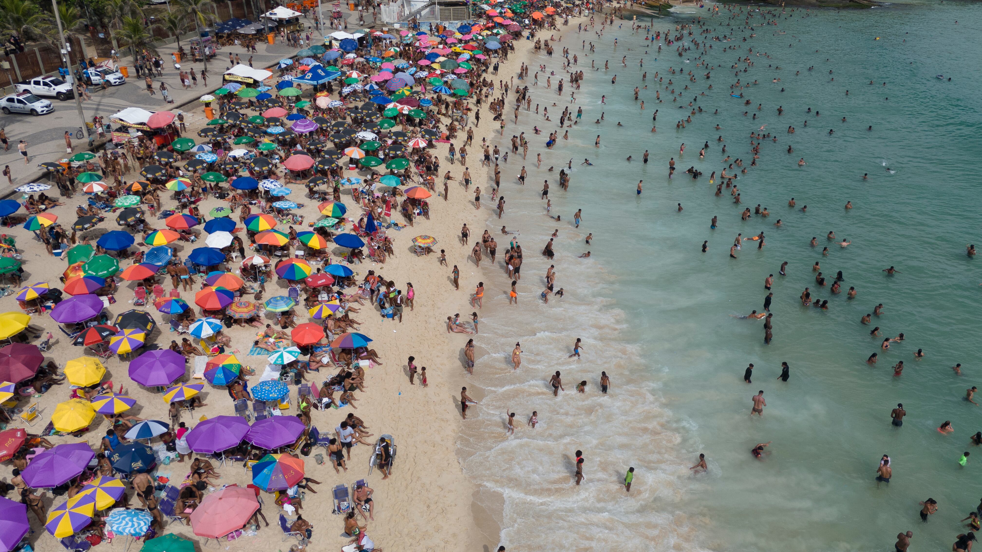 Aerial view of people enjoying Arpoador beach in Rio de Janeiro, Brazil, on February 9, 2025. (Photo by Pablo PORCIUNCULA / AFP)