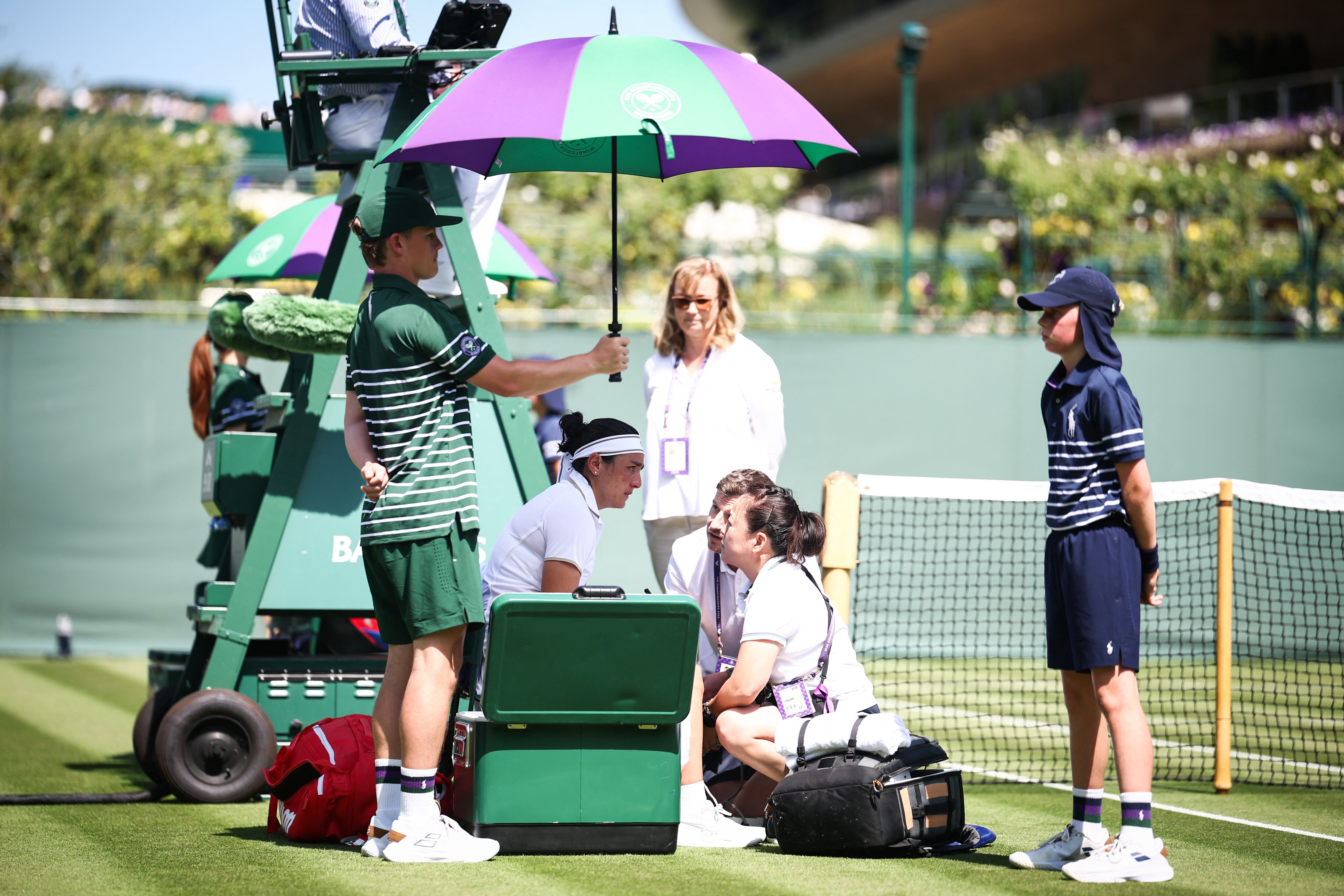 Ons Jabeur recibe asistencia médica en el partido cotra Viktoriya Tomova en el primer día de Wimbledon. Ella no pudo continuar.