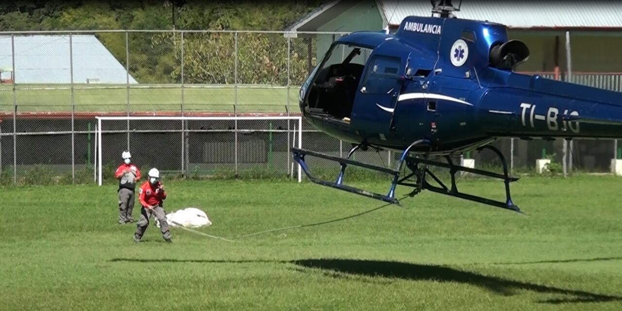 Toda una estrategia de rescate, quitando peso al helicóptero, permitió en un segundo intento atar el cuerpo de la montañista a una cuerda y llevarlo así hasta la plaza de fútbol de San Gerardo de Rivas. Foto: Mario Cordero.