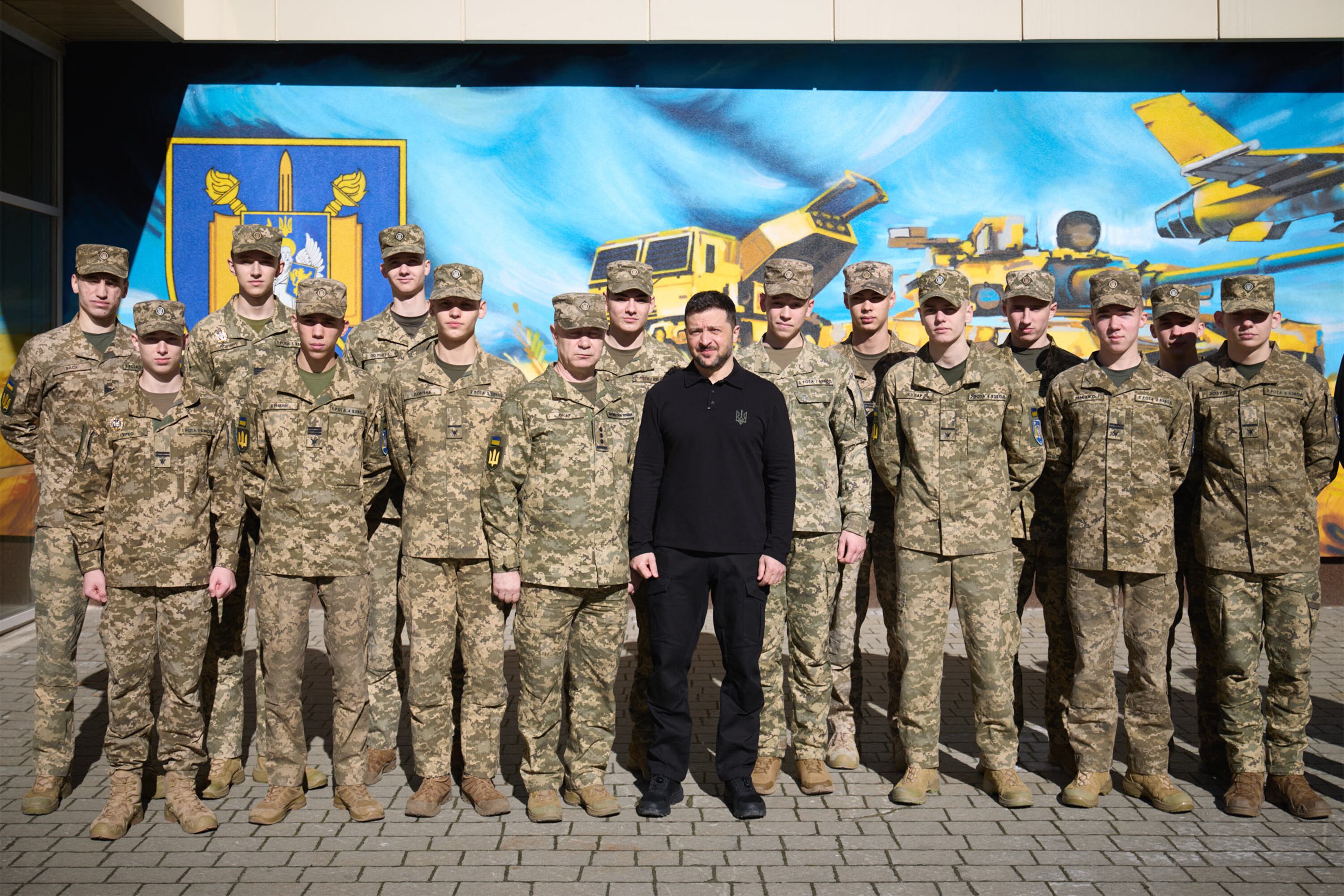Ukrainian President Volodymyr Zelensky (C) posing for a photo with students during a visit at the Kruty Heroes Lviv Lyceum for Advanced Military and Physical Training in Lviv, amid the Russian invasion of Ukraine. (Photo by Handout / UKRAINIAN PRESIDENTIAL PRESS SERVICE / AFP