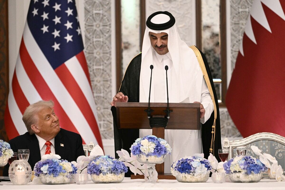Qatar's Emir Sheikh Tamim bin Hamad al-Thani (R) and US President Donald Trump sit side by side at the Royal Palace in Doha on May 14, 2025. Trump touched down at Hamad International Airport in Doha, with relations between the two governments in the spotlight over Qatar's offer to Trump of a $400 million luxury aircraft to serve as a new Air Force One and then pass into his personal use. (Photo by Brendan SMIALOWSKI / AFP)