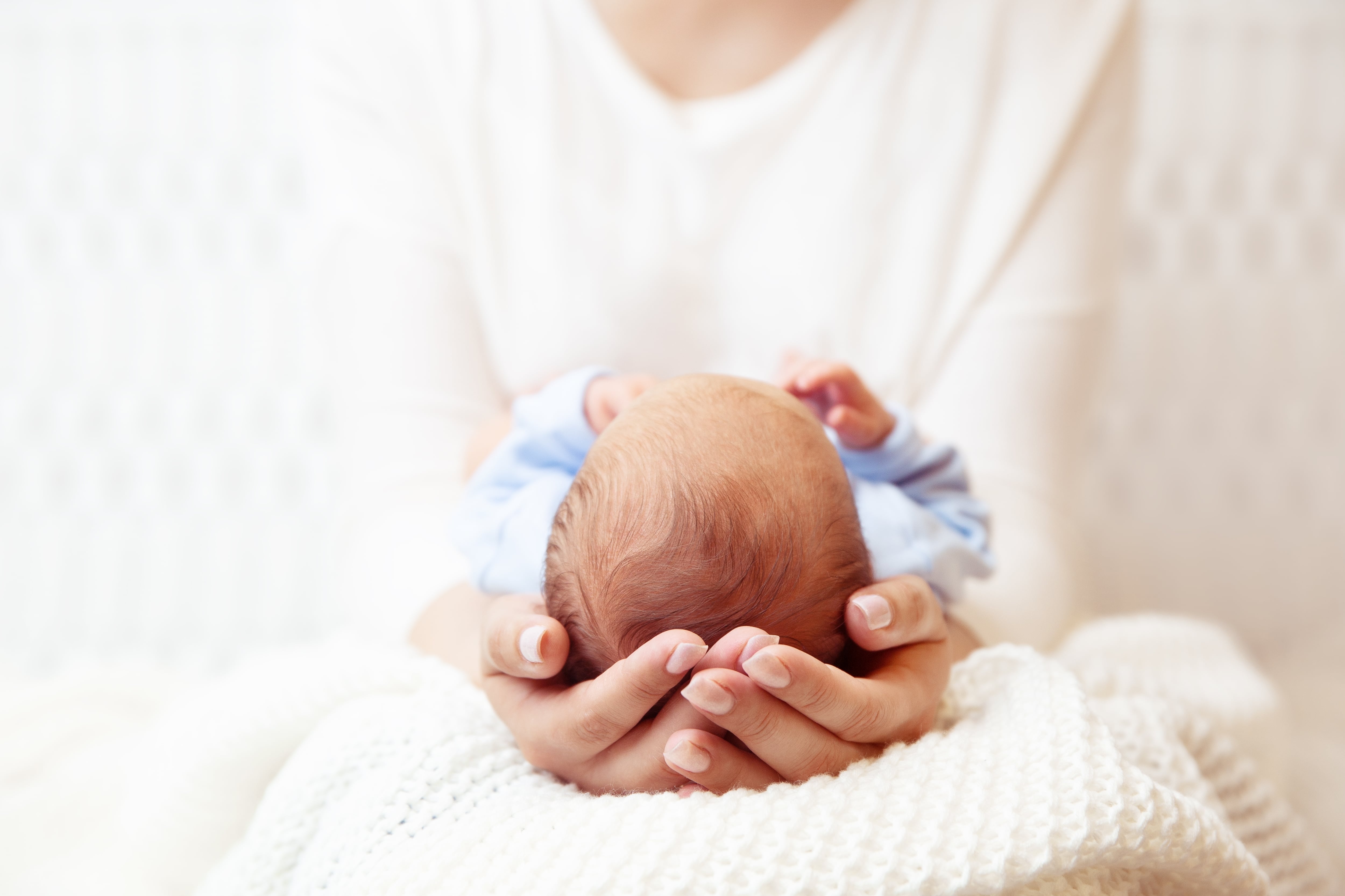 Baby,Head,In,Mother,Hands.,Mum,Holding,Newborn,Boy,Lying
