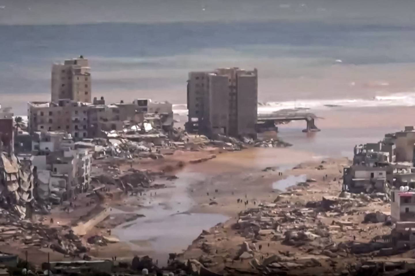 Esta imagen extraída de imágenes publicadas en las redes sociales por el canal de televisión libio al-Masar el 13 de septiembre muestra una vista aérea de los grandes daños causados ​​por las inundaciones después de que la tormenta mediterránea "Daniel" azotara la ciudad de Derna